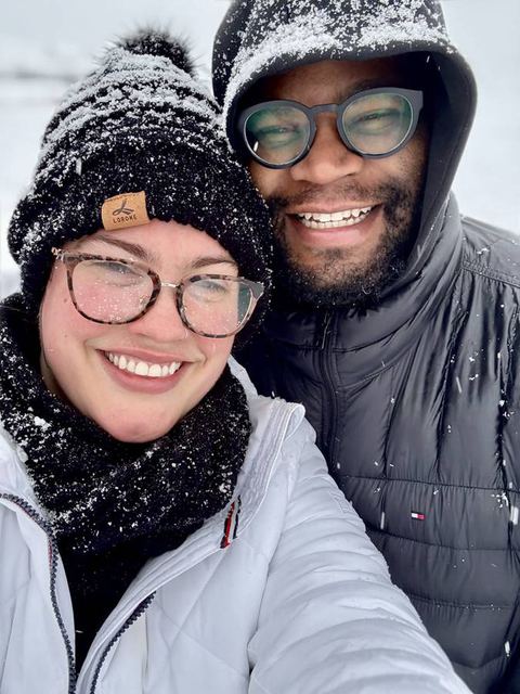 Hailey and Tristan bundled in winter hats, cheeks together
