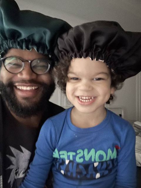 Tristan and their son making silly faces at the camera