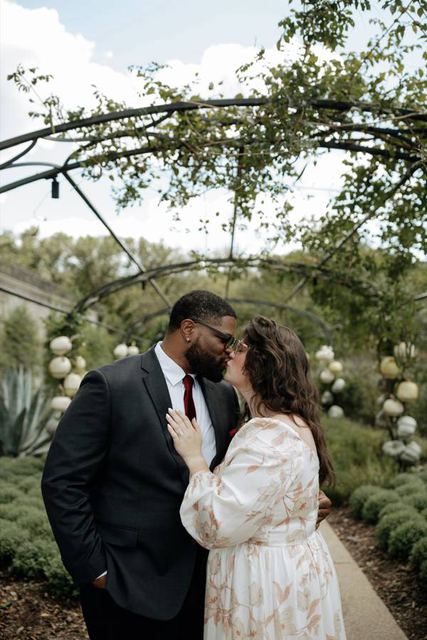 Hailey and Tristan kissing in the garden